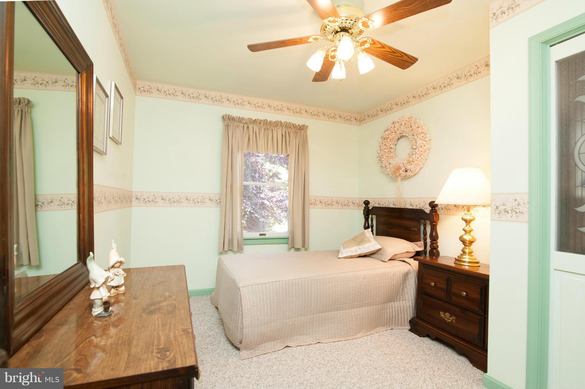 6151 Oklahoma Road Sykesville, MD 21784 - Photo 7 of 23 a bedroom with a bed and a chandelier
