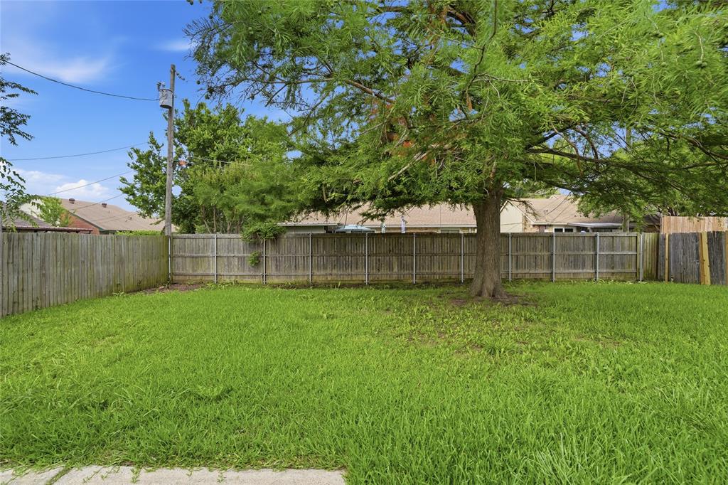 403 Redbud Drive Forney, TX 75126 - Photo 16 of 17 a view of a backyard with a plants and large trees
