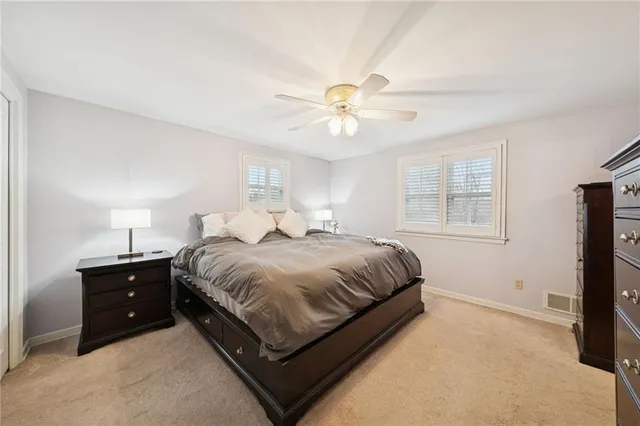 a spacious bedroom with a bed and a window