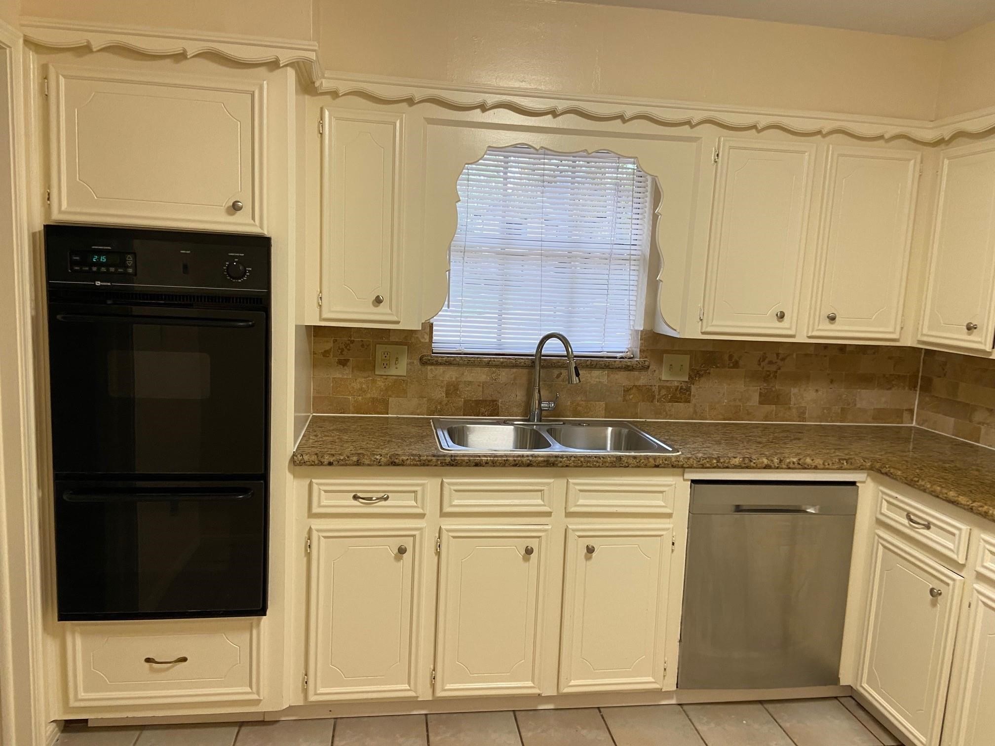 3418 Candlewisp Drive Spring, TX 77388 - Photo 4 of 16 a kitchen with white cabinets and a sink