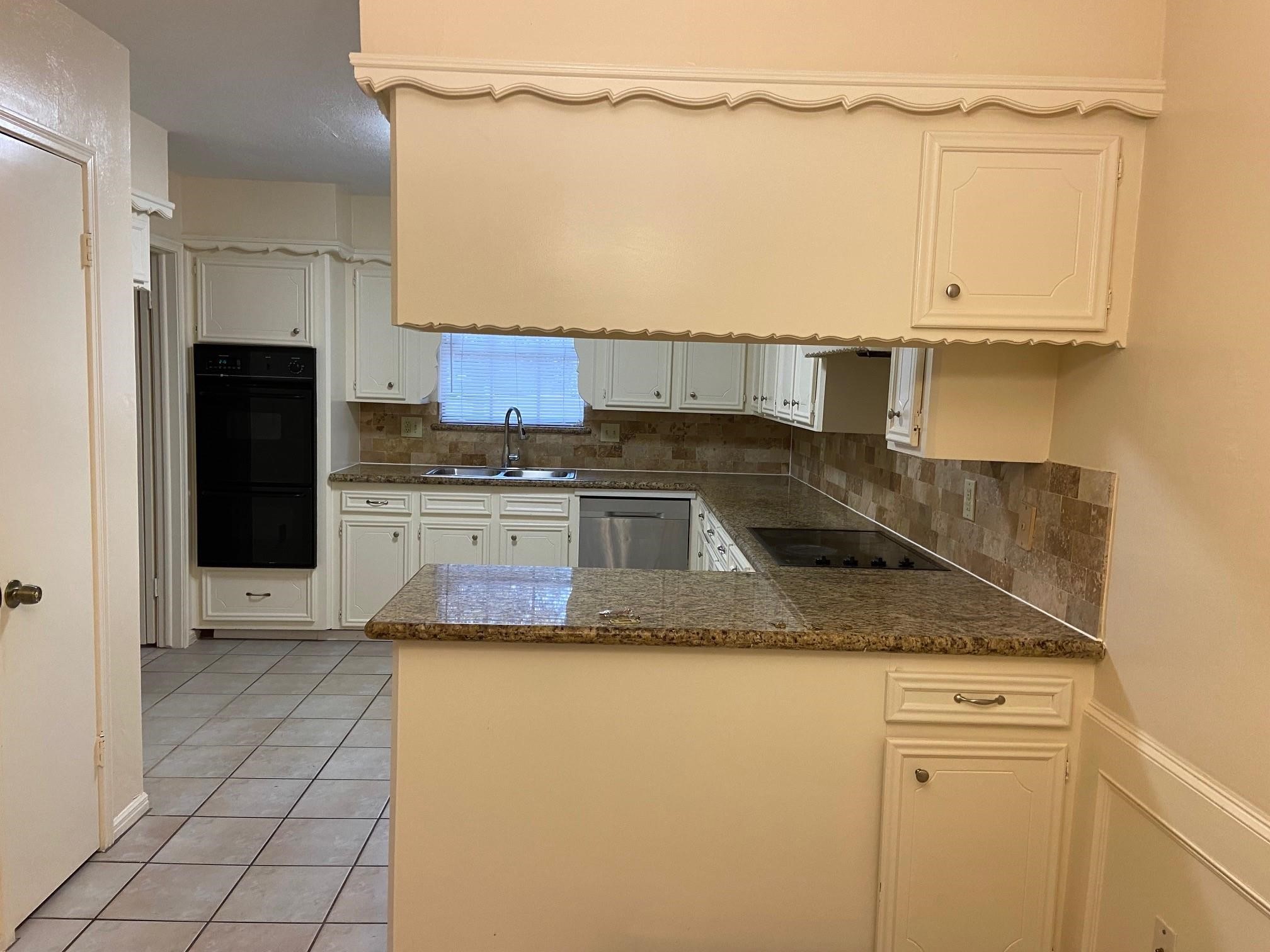3418 Candlewisp Drive Spring, TX 77388 - Photo 5 of 16 a kitchen with a sink a refrigerator and cabinets