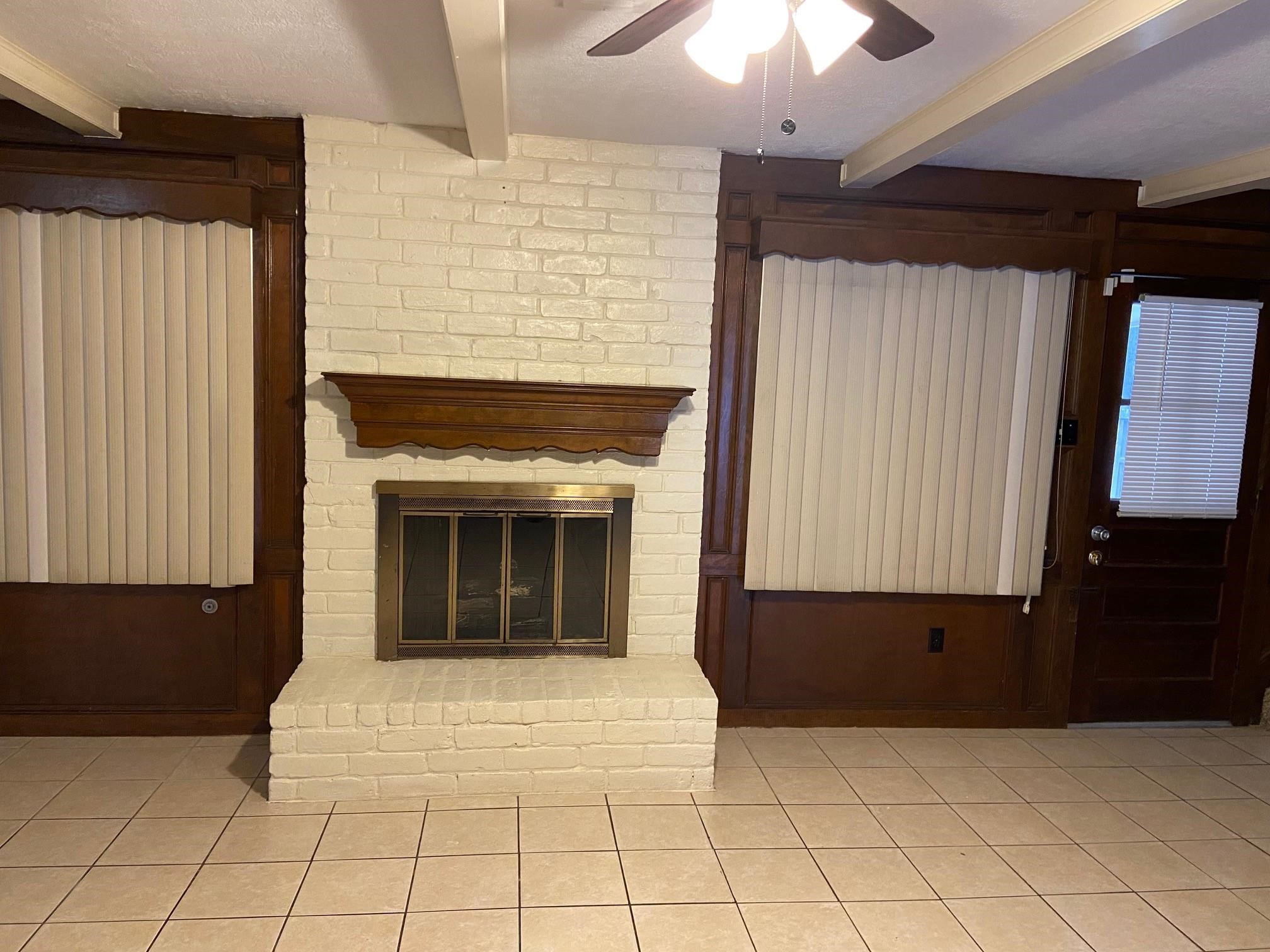 3418 Candlewisp Drive Spring, TX 77388 - Photo 9 of 16 a view of an empty room with a fireplace and a chandelier