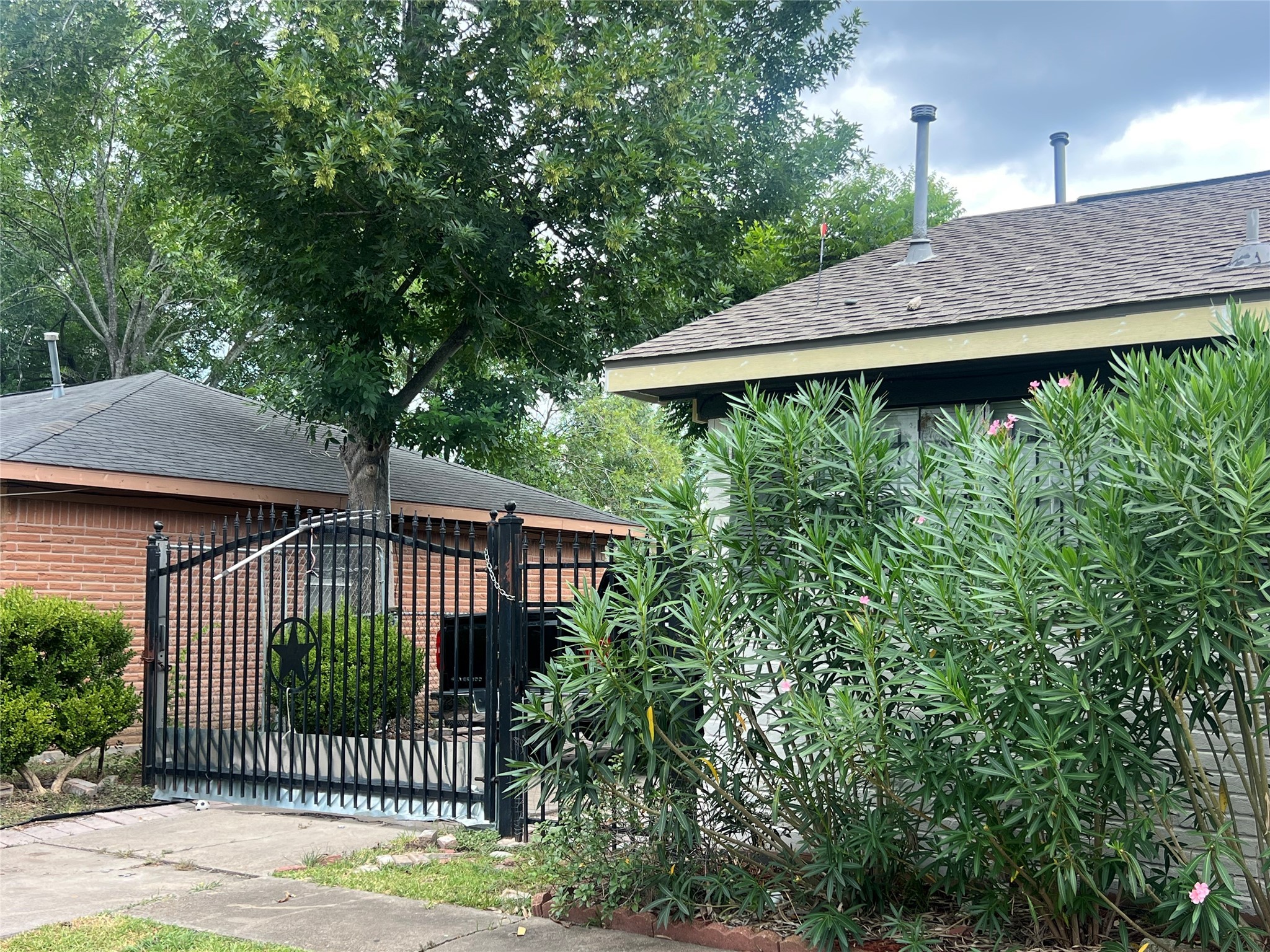 4118 Ebbtide Drive Houston, TX 77045 - Photo 3 of 14 a view of a wooden house with a small yard and large trees