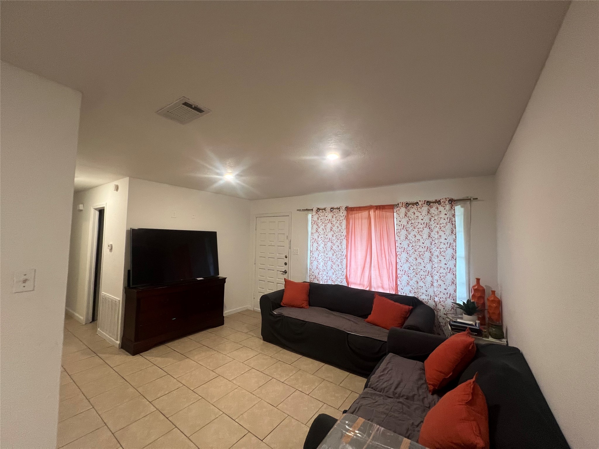 4118 Ebbtide Drive Houston, TX 77045 - Photo 6 of 14 a living room with furniture and a flat screen tv