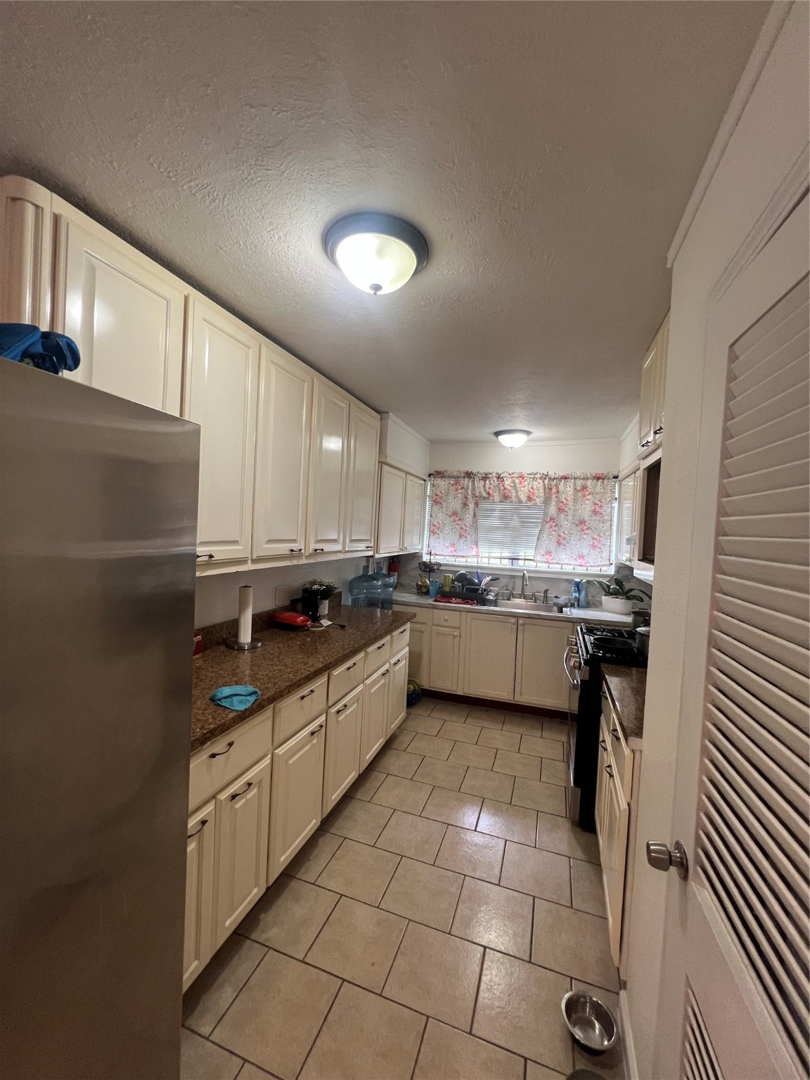 4118 Ebbtide Drive Houston, TX 77045 - Photo 7 of 14 a kitchen with a sink a counter top space stainless steel appliances and cabinets