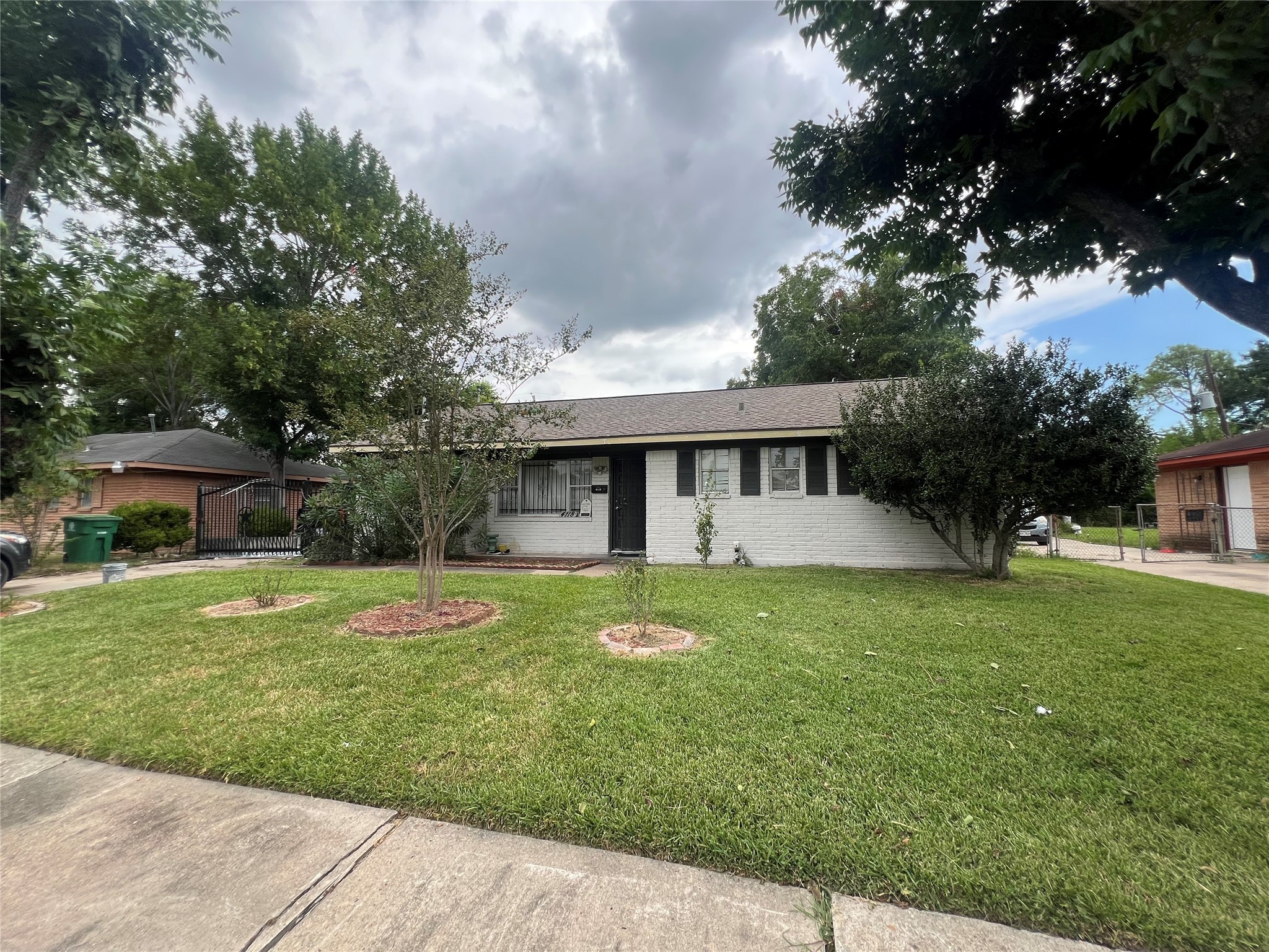 4118 Ebbtide Drive Houston, TX 77045 - Photo 10 of 14 a front view of a house with a garden