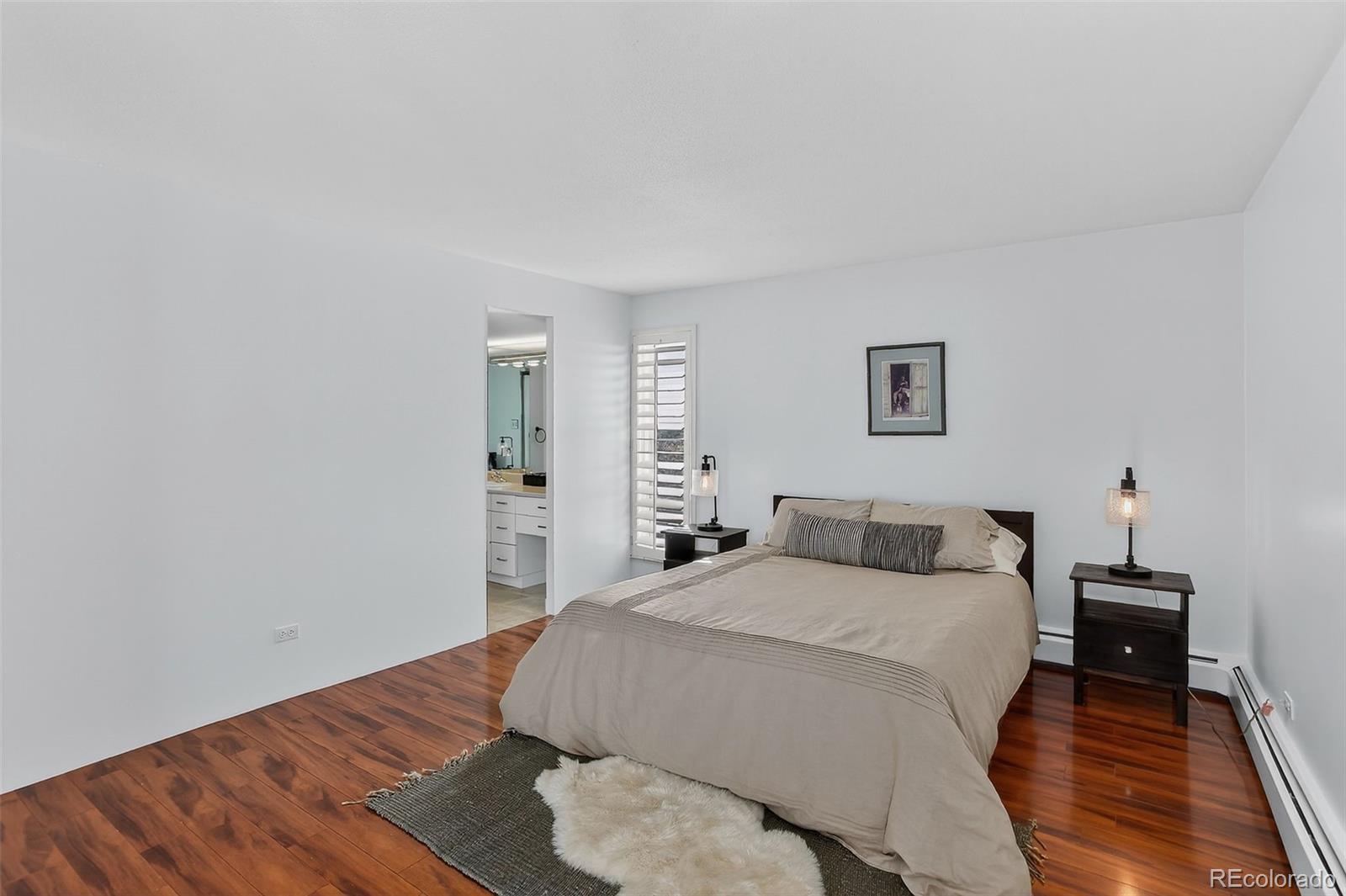 955 Eudora Street, Unit 1601 Denver, CO 80220 - Photo 15 of 36 a bedroom with a bed and wooden floor