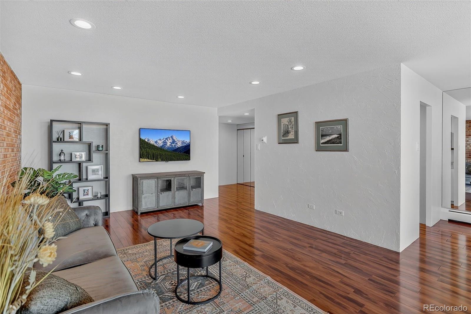 955 Eudora Street, Unit 1601 Denver, CO 80220 - Photo 2 of 36 a living room with furniture and wooden floor