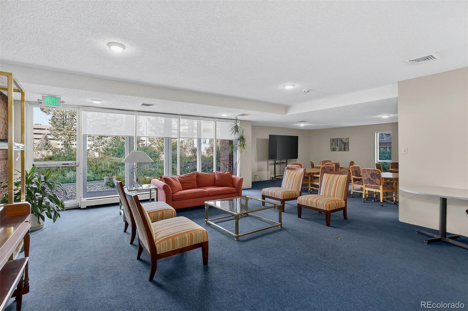 955 Eudora Street, Unit 1601 Denver, CO 80220 - Photo 31 of 36 a living room with furniture and a floor to ceiling window