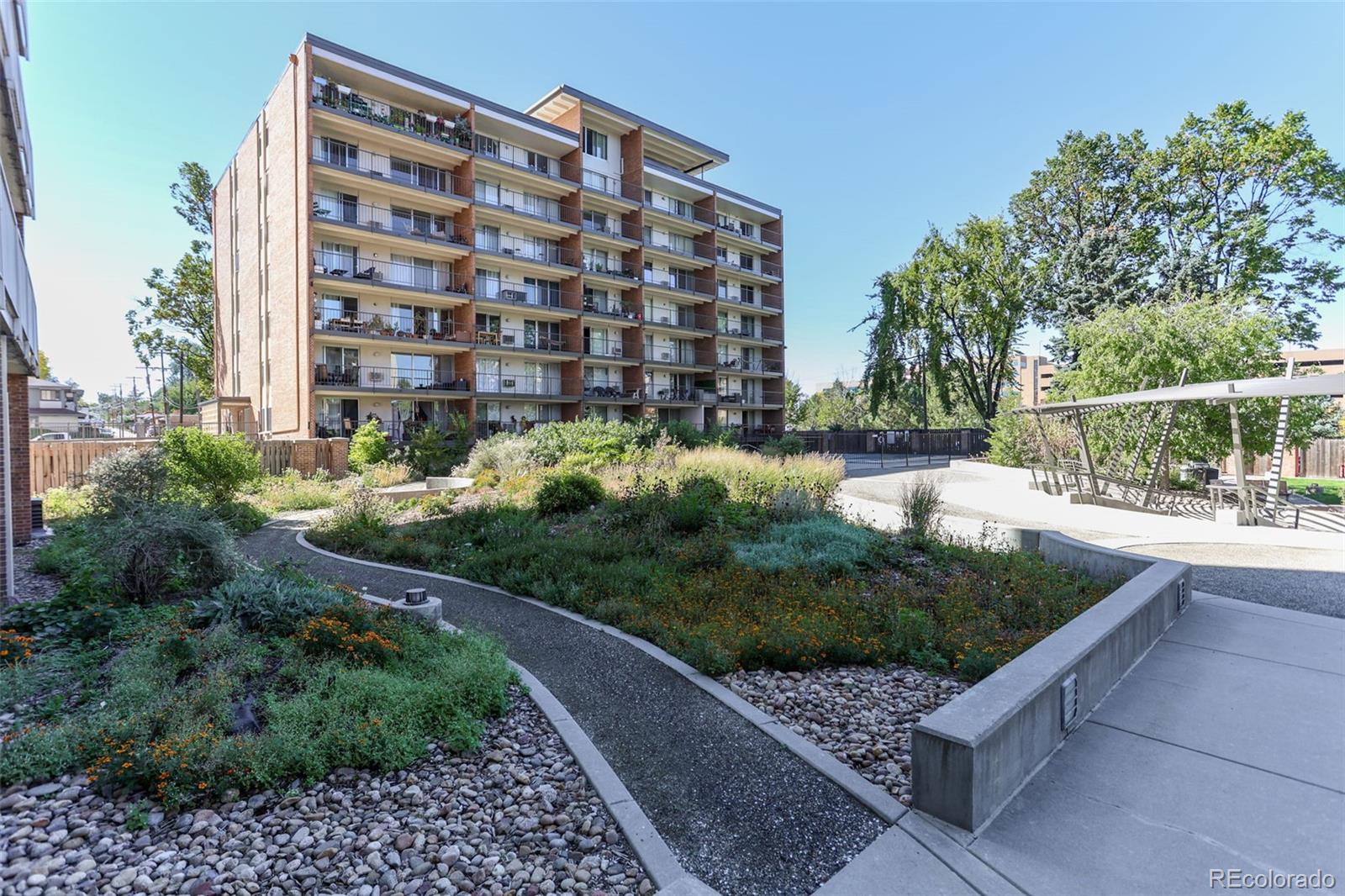 955 Eudora Street, Unit 1601 Denver, CO 80220 - Photo 33 of 36 a view of a tall building and a garden