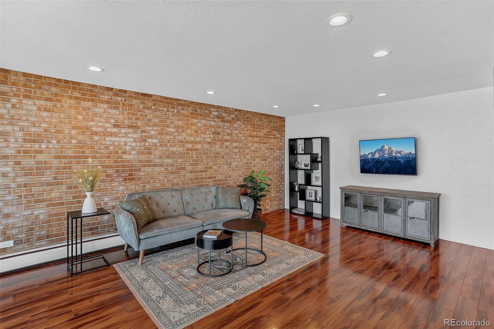 955 Eudora Street, Unit 1601 Denver, CO 80220 - Photo 4 of 36 a living room with furniture and wooden floor