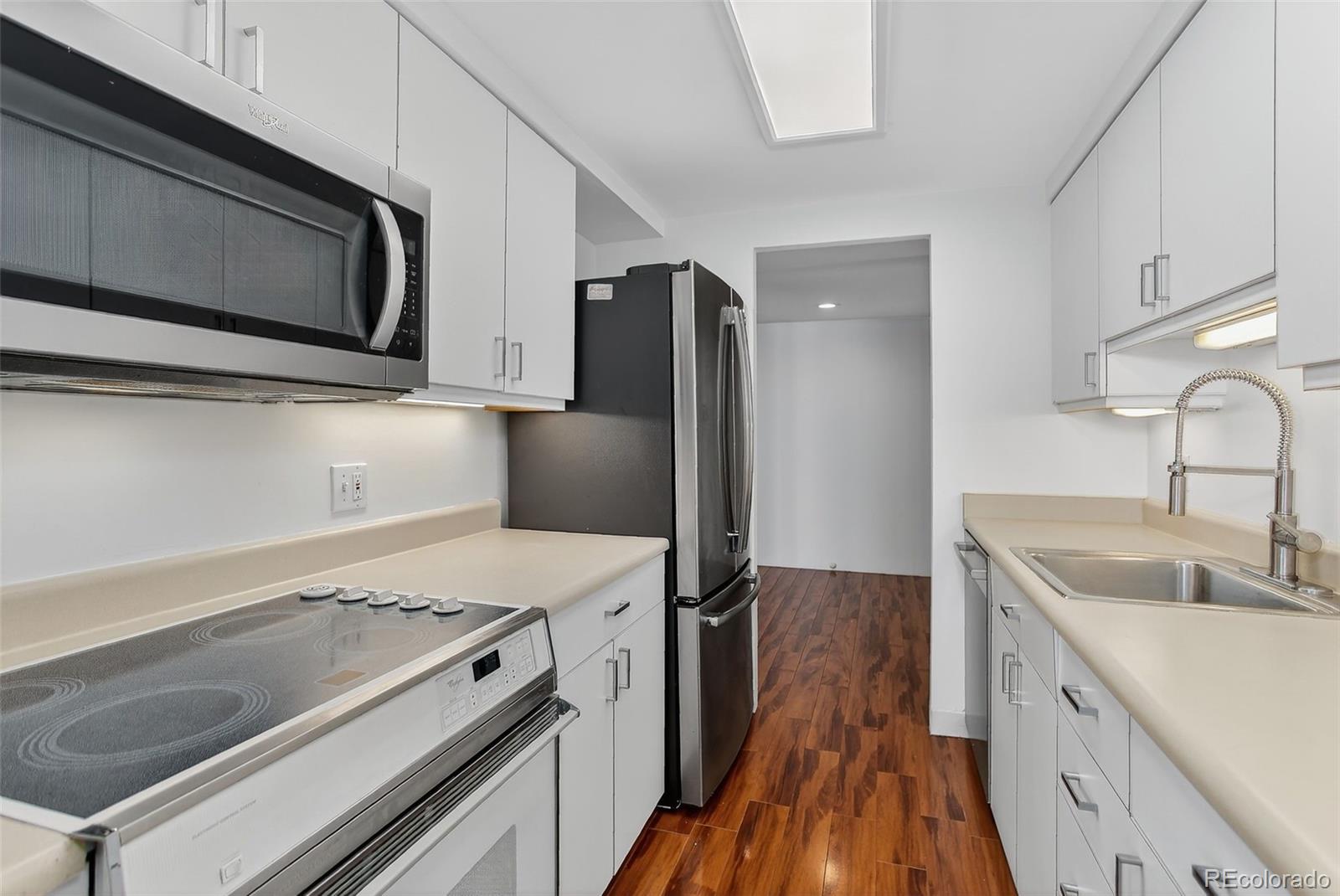 955 Eudora Street, Unit 1601 Denver, CO 80220 - Photo 9 of 36 a kitchen with a sink stove and refrigerator