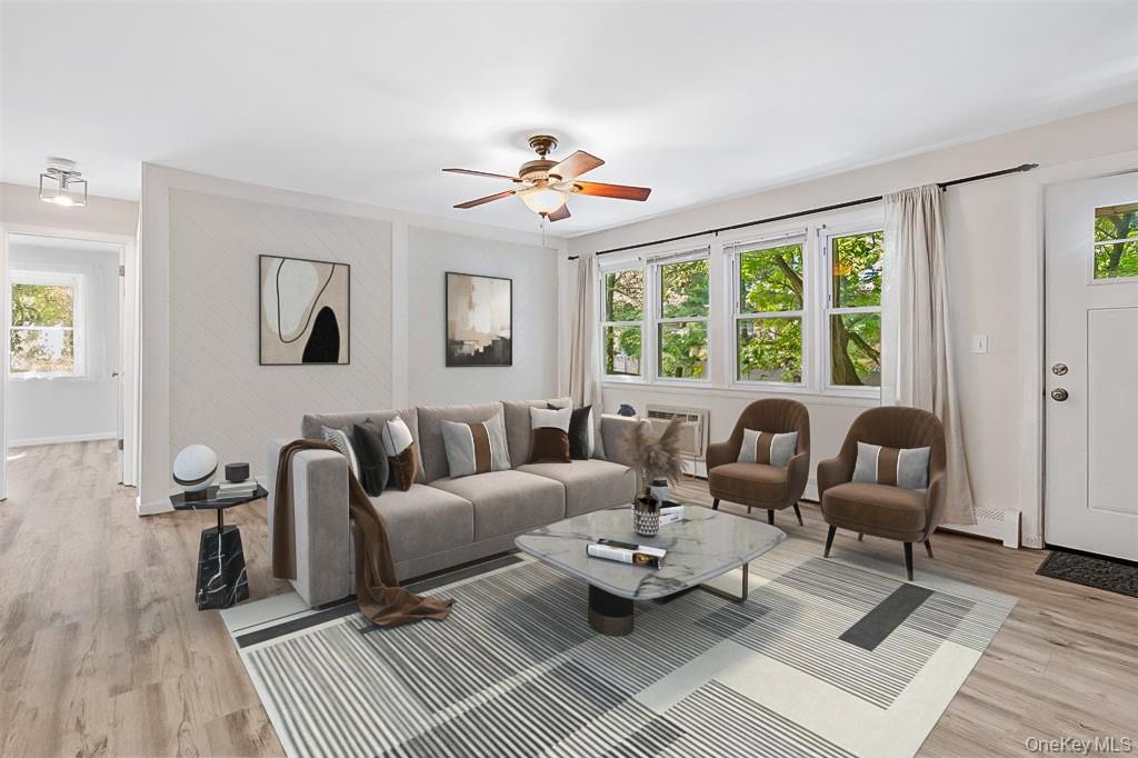 68 Gerald Drive, Unit D1 Poughkeepsie, NY 12601 - Photo 7 of 29 Living area with light wood-style floors, ceiling fan, and a baseboard heating unit