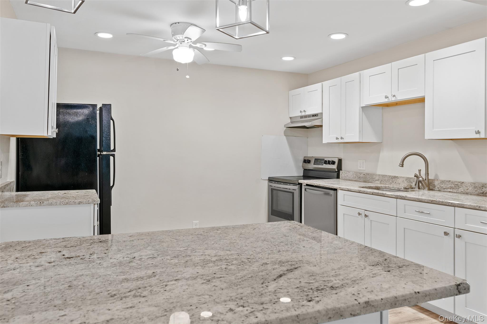 68 Gerald Drive, Unit D1 Poughkeepsie, NY 12601 - Photo 9 of 29 Kitchen featuring under cabinet range hood, stainless steel appliances, white cabinetry, ceiling fan, and recessed lighting