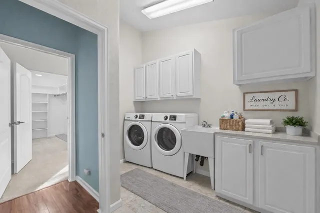 a utility room with sink dryer and washer