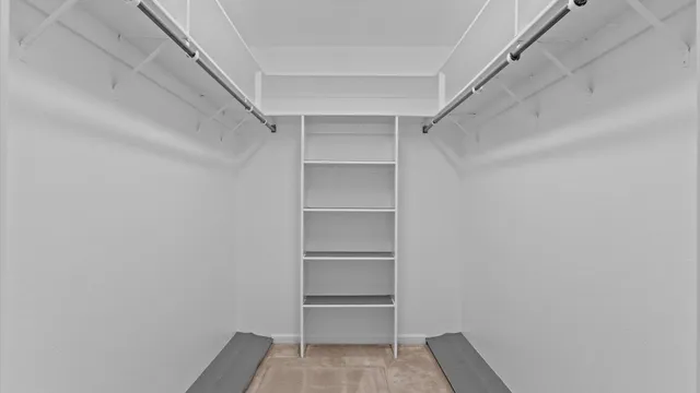 a bathroom with a granite countertop double vanity sink a mirror and a shower