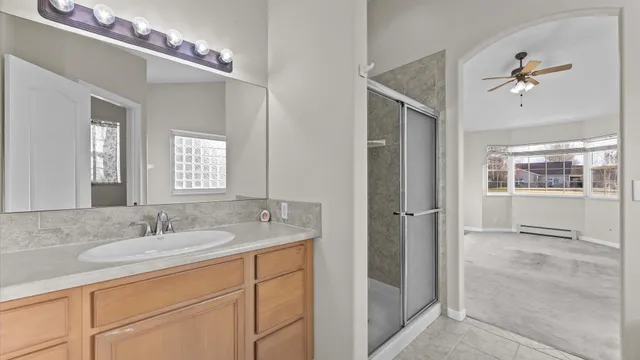 a bathroom with a tub shower and sink