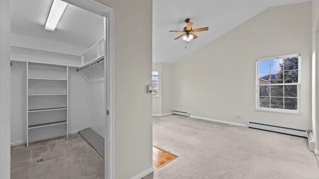 a view of a livingroom with furniture and a refrigerator