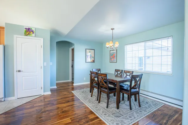 a view of a dining room with furniture window and wooden floor