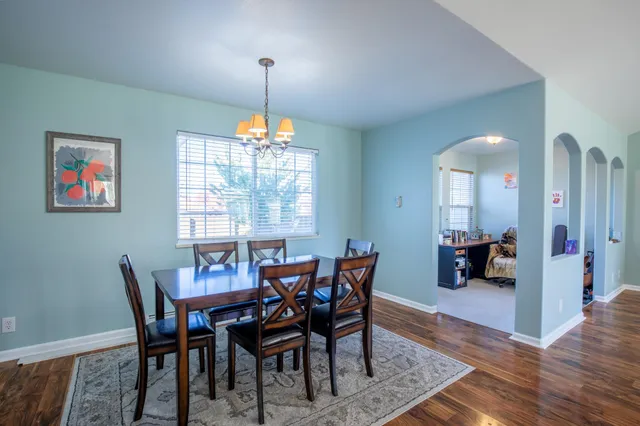 a view of a dining room with furniture wooden floor and chandelier