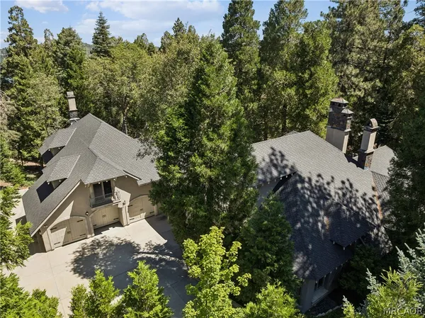 an aerial view of a house with yard and outdoor seating
