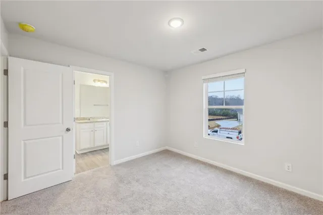 an empty room with windows and closet