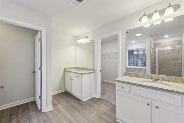 a bathroom with a granite countertop sink mirror and double