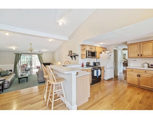 31 Merilyn Road Weymouth, MA 02190 - Photo 5 of 25 a open kitchen with stainless steel appliances kitchen island granite countertop a stove top oven a sink a dining table and chairs