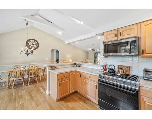 31 Merilyn Road Weymouth, MA 02190 - Photo 7 of 25 a kitchen with stainless steel appliances granite countertop a stove a sink and a microwave
