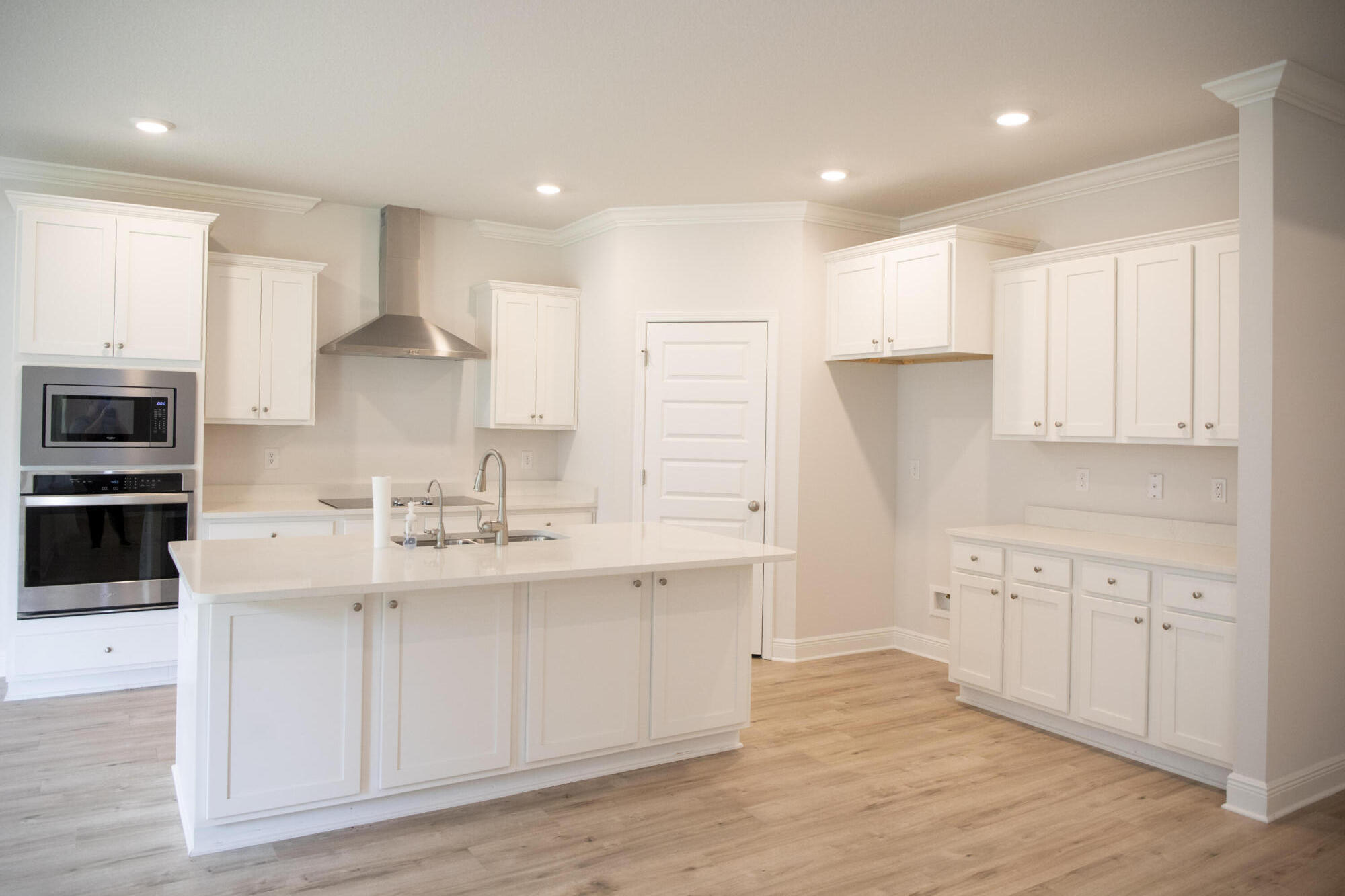 56 Secluded Circle Freeport, FL 32439 - Photo 15 of 26 a kitchen with stainless steel appliances granite countertop a sink a stove a refrigerator and island with wooden floor