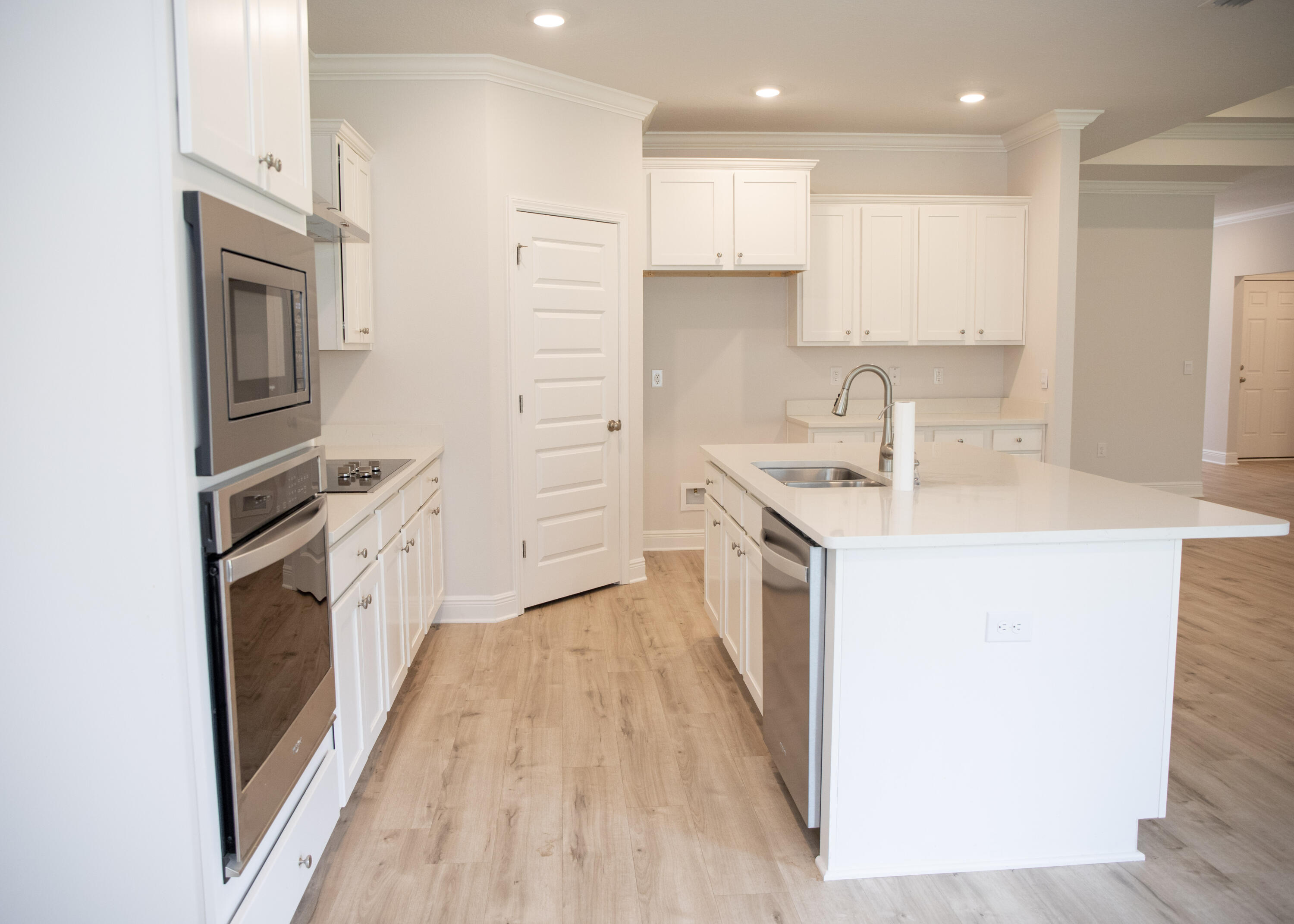 56 Secluded Circle Freeport, FL 32439 - Photo 16 of 26 a kitchen with white cabinets and appliances