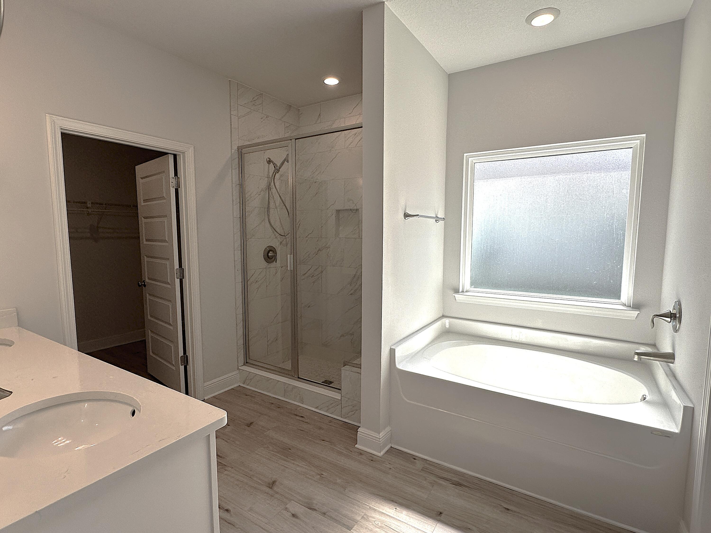 56 Secluded Circle Freeport, FL 32439 - Photo 21 of 26 a bathroom with a tub a sink and a large mirror