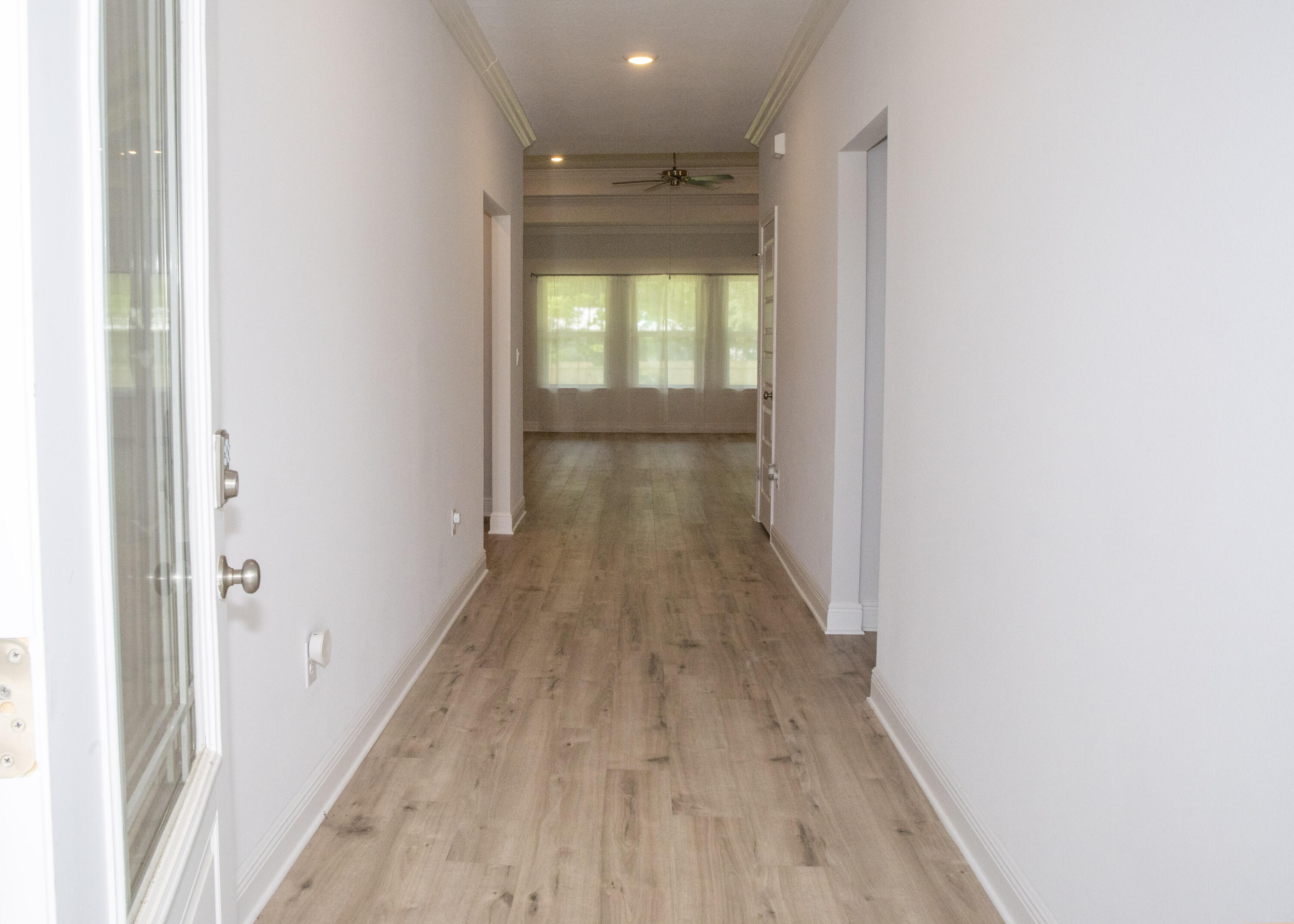 56 Secluded Circle Freeport, FL 32439 - Photo 3 of 26 a view of a hallway with wooden floor