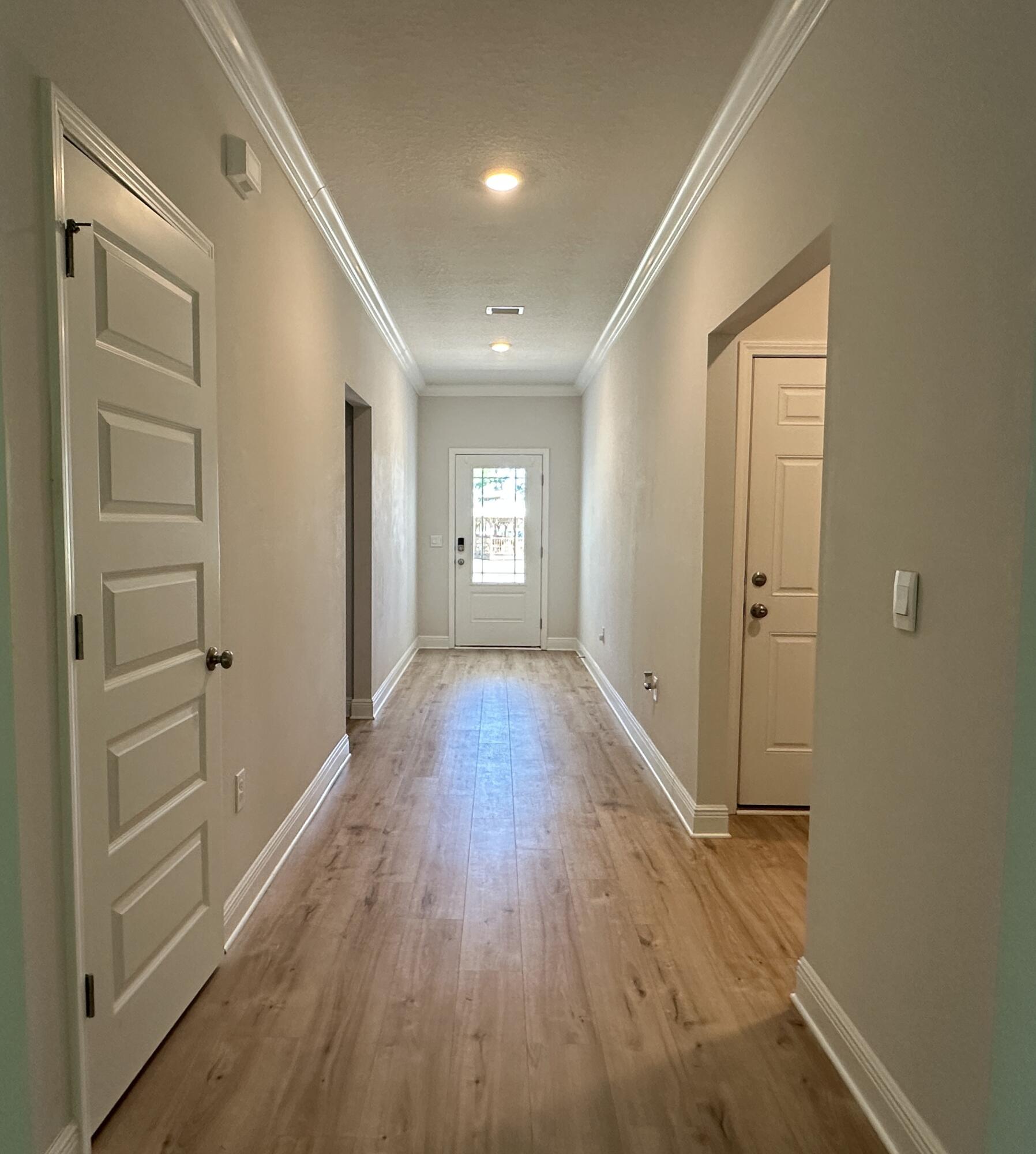 56 Secluded Circle Freeport, FL 32439 - Photo 4 of 26 a view of hallway with wooden floor and window