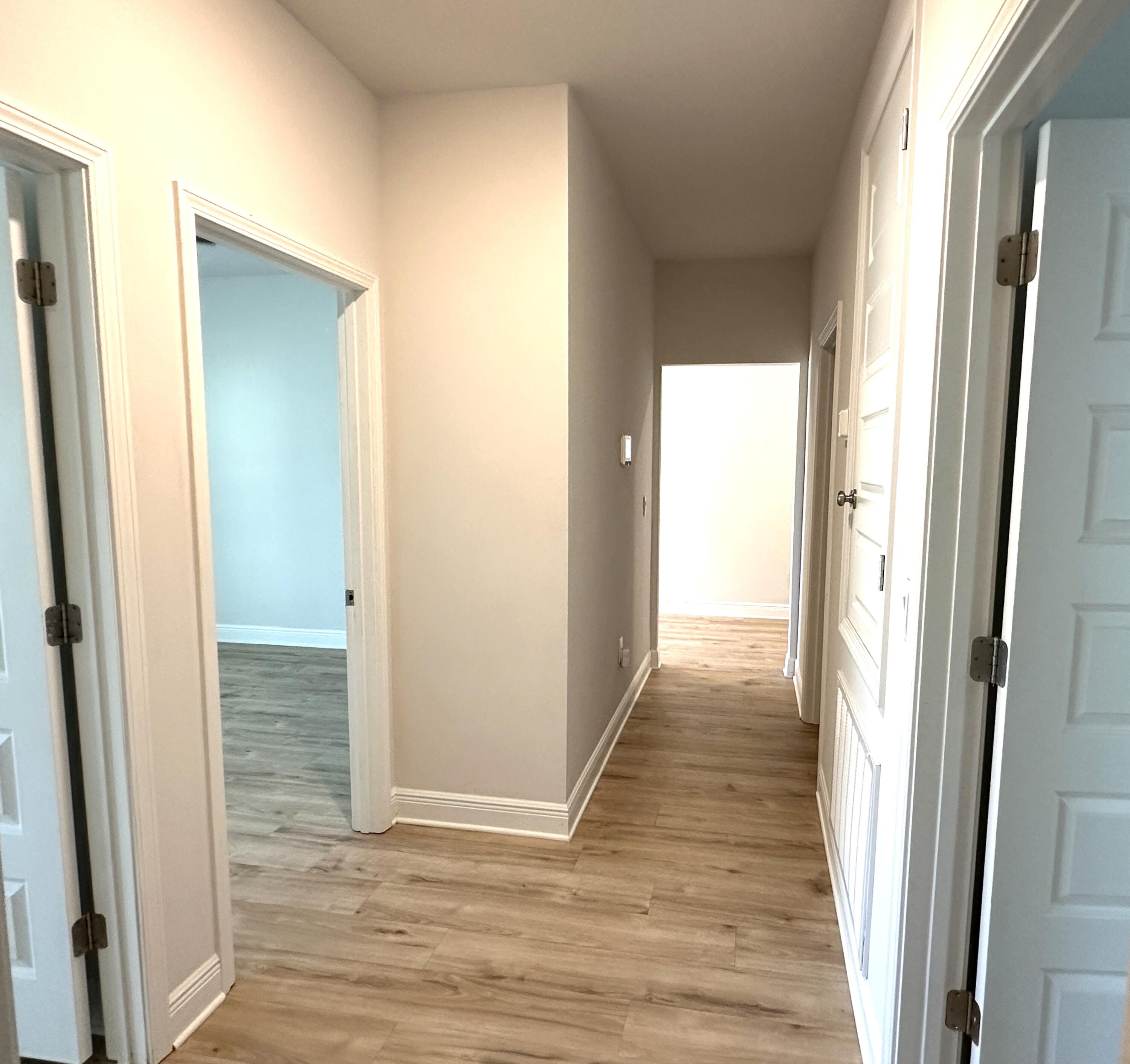 56 Secluded Circle Freeport, FL 32439 - Photo 6 of 26 a view of a hallway with wooden floor