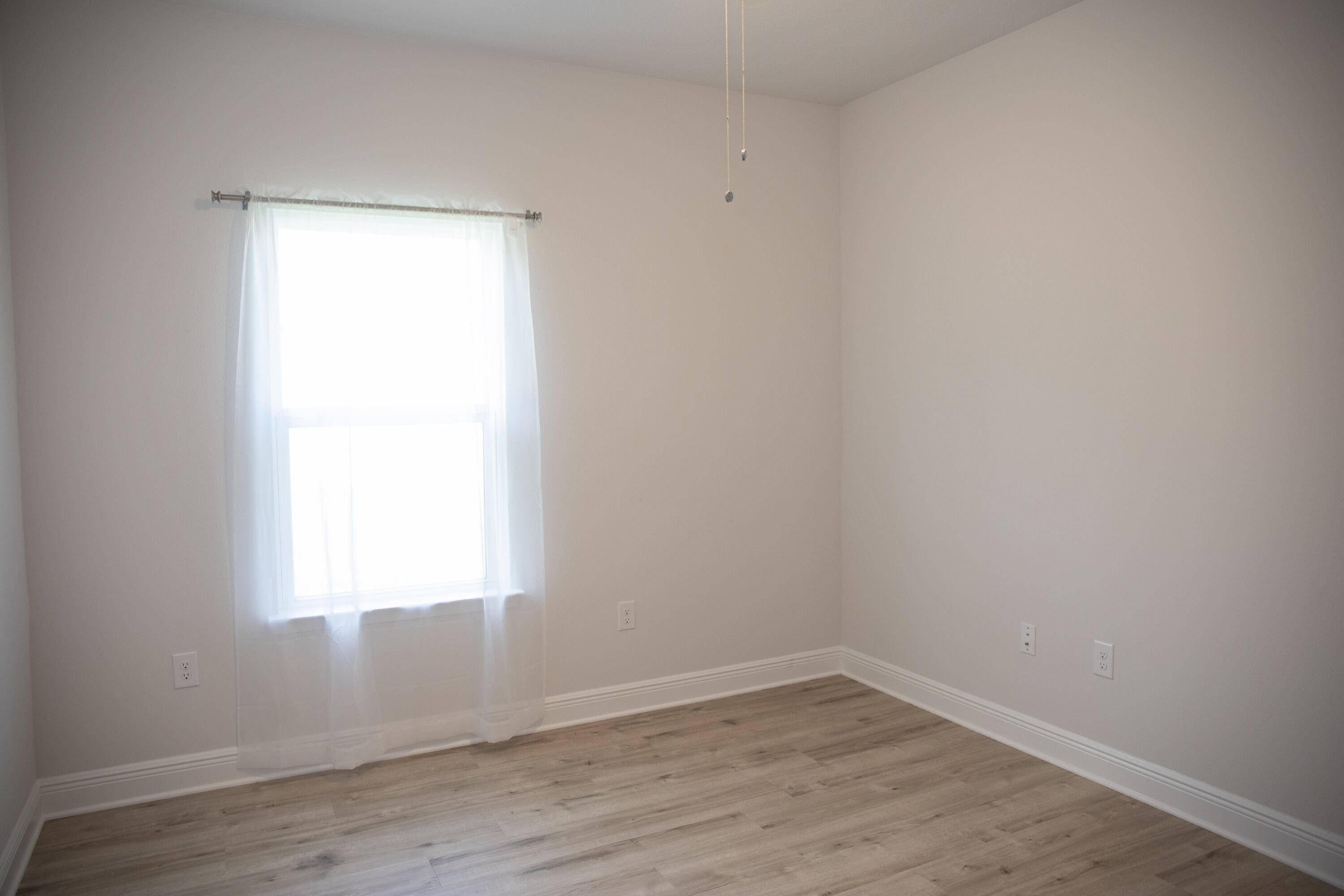 56 Secluded Circle Freeport, FL 32439 - Photo 9 of 26 a view of an empty room with wooden floor and a window