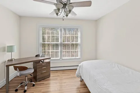 a bedroom with a bed and a desk