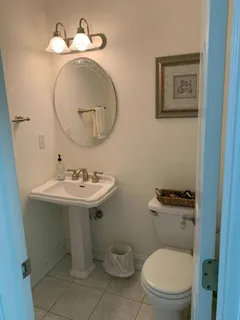a bathroom with a toilet a sink and a mirror
