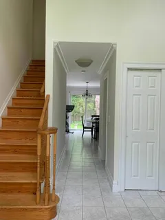 a view of entryway and hall with wooden floor