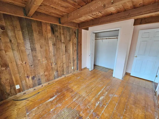 a view of hallway with wooden floor