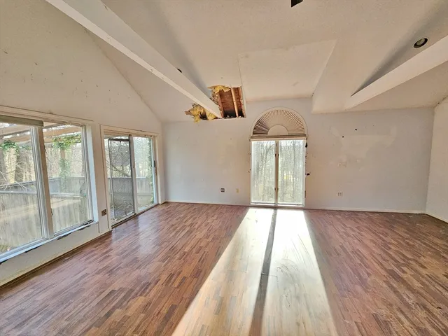 wooden floor in an empty room with a window