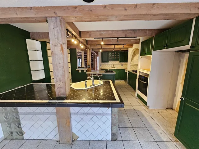 a large kitchen with cabinets and stainless steel appliances