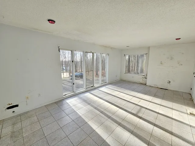 a spacious bedroom with a bed and a window