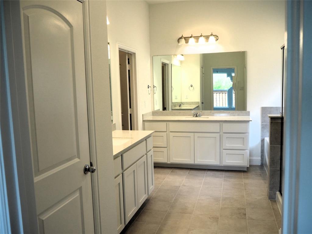 2201 Yellowhammer Road Denton, TX 76205 - Photo 15 of 36 a bathroom with a sink vanity and mirror