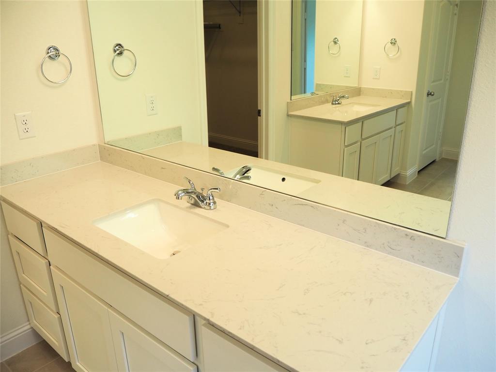 2201 Yellowhammer Road Denton, TX 76205 - Photo 16 of 36 a bathroom with a sink and a mirror