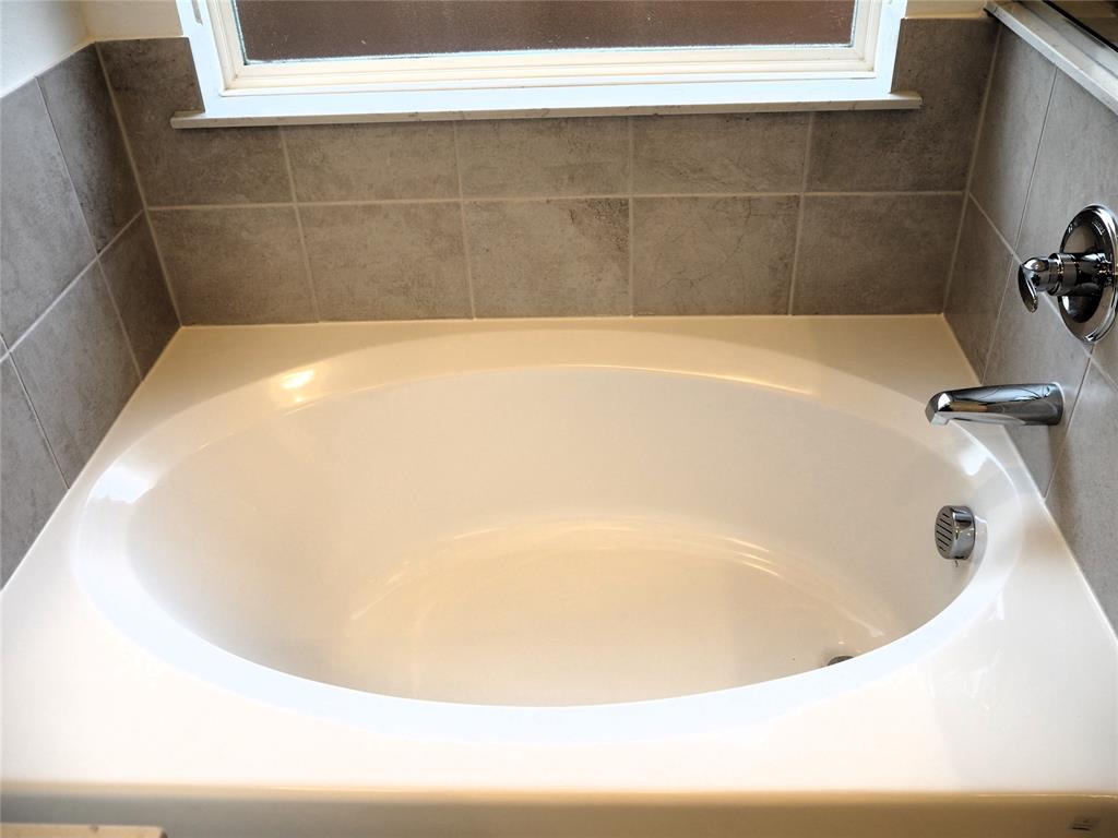 2201 Yellowhammer Road Denton, TX 76205 - Photo 17 of 36 a white bath tub sitting in a bathroom