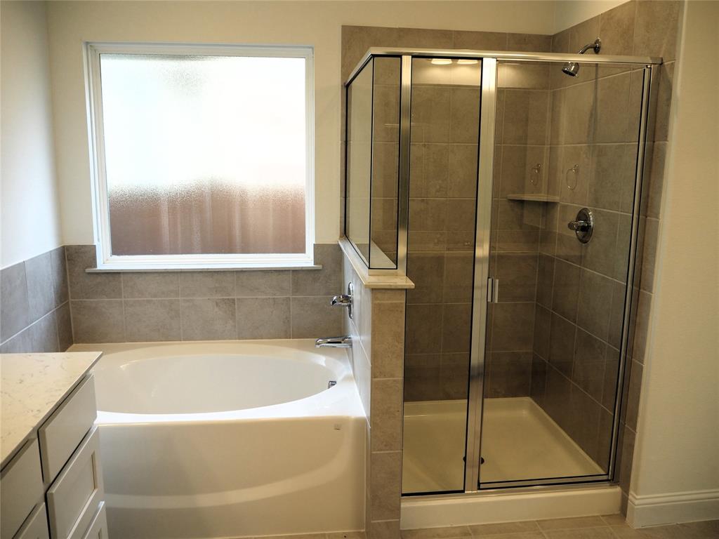 2201 Yellowhammer Road Denton, TX 76205 - Photo 18 of 36 a bathroom with a bathtub and shower