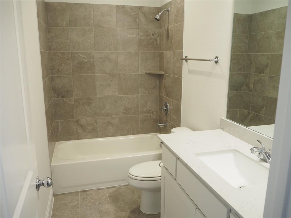 2201 Yellowhammer Road Denton, TX 76205 - Photo 28 of 36 a bathroom with a sink a toilet and a bathtub