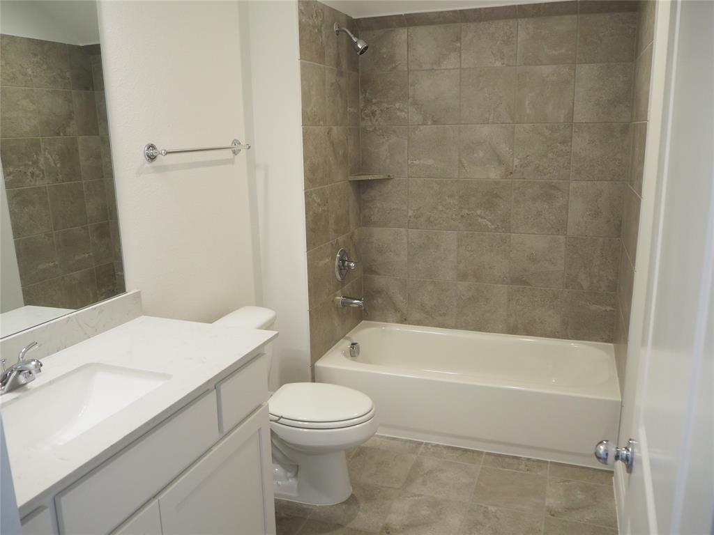 2201 Yellowhammer Road Denton, TX 76205 - Photo 29 of 36 a bathroom with a toilet a sink and bathtub