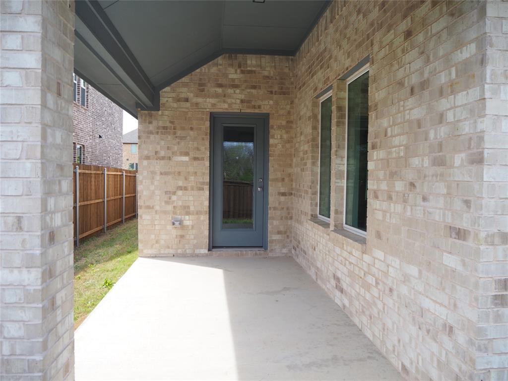 2201 Yellowhammer Road Denton, TX 76205 - Photo 31 of 36 a view of a brick house with a large window